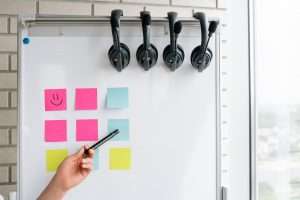 whiteboard with sticky notes and headsets