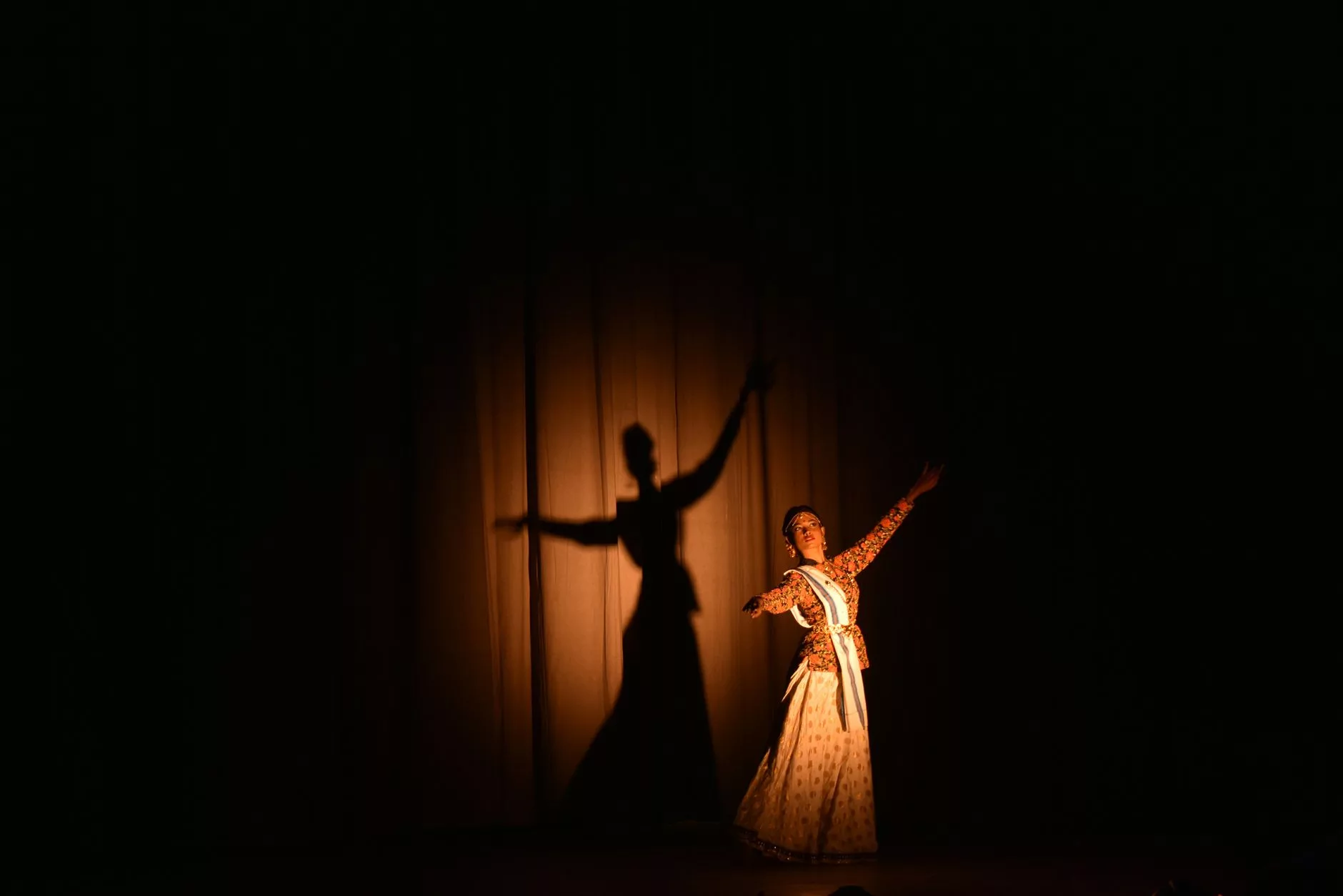 traditional indian dance performance under spotlight